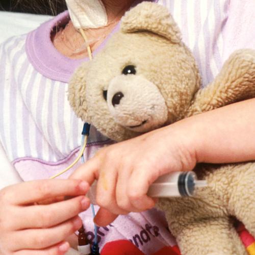Pediatric Cancer Patient Holding Teddy Bear