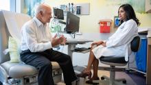 Aparajita Singh, MD, meets with patient Bill Shea, who was previously diagnosed with colon cancer. Photo by Deanne Fitzmaurice