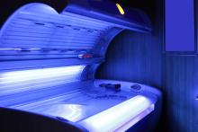 A tanning bed emitting a soft blue glow.