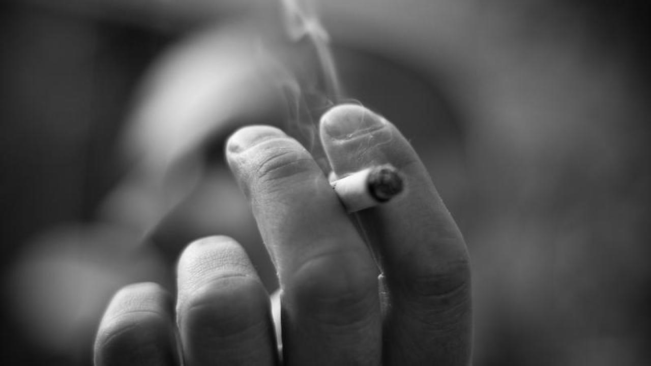 Hand with cigarette and smoke