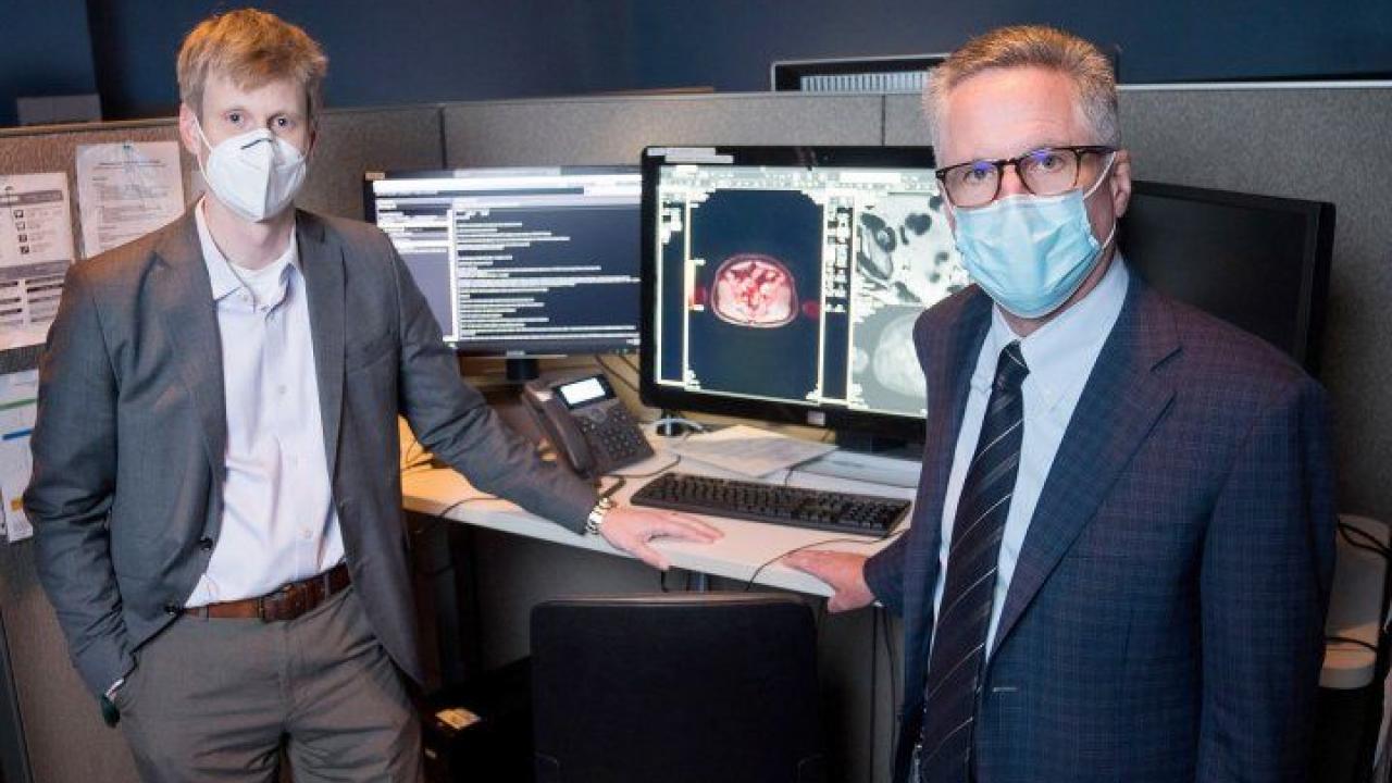 Thomas Hope (left), MD, and Peter Carroll, MD, stand at the PACS workstation where the images from the PSMA PETs are viewed and interpreted. The imaging technique received FDA approval in 2020. Photo by Maurice Ramirez Drs. Hope and Carroll
