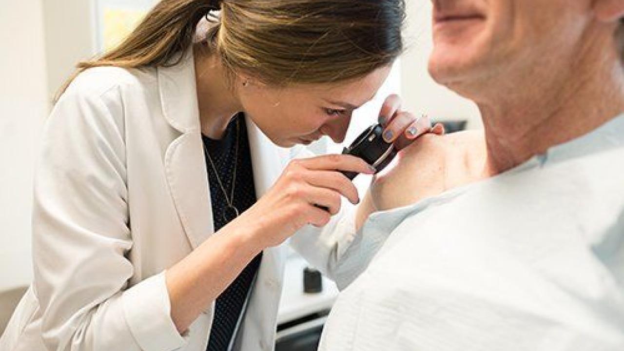 Carina Woodruff, MD, examines a patient during a free skin cancer screening at UCSF. Photo: Barbara Ries