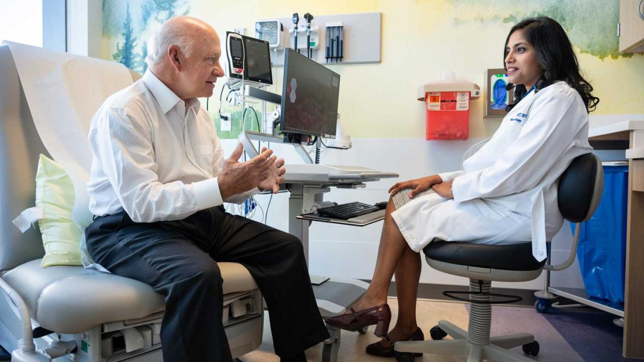 Aparajita Singh, MD, meets with patient Bill Shea, who was previously diagnosed with colon cancer. Photo by Deanne Fitzmaurice