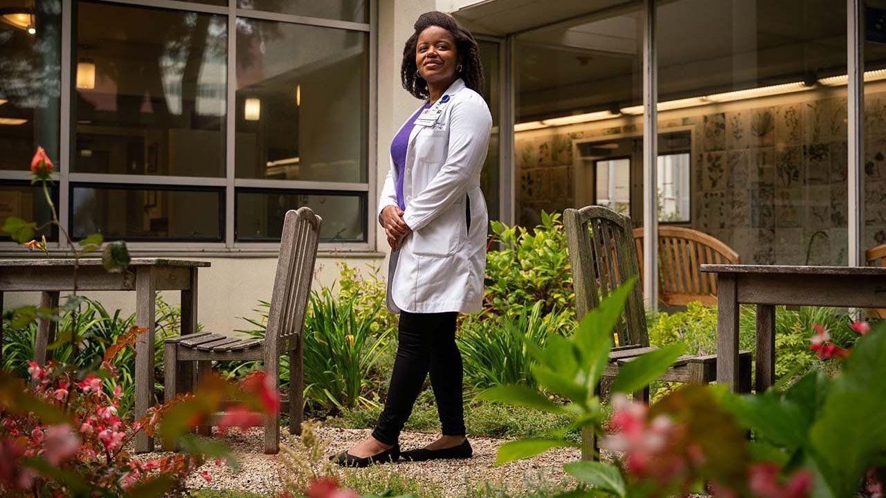 Jenna Lester founded the UCSF Skin of Color Program to improve dermatological care for people with dark skin, whose images are often excluded from training literature. Photo: Sarahbeth Maney Dermatologist Jenna Lester stands in the garden outside the medical building on the Parnassus Campus of UCSF.