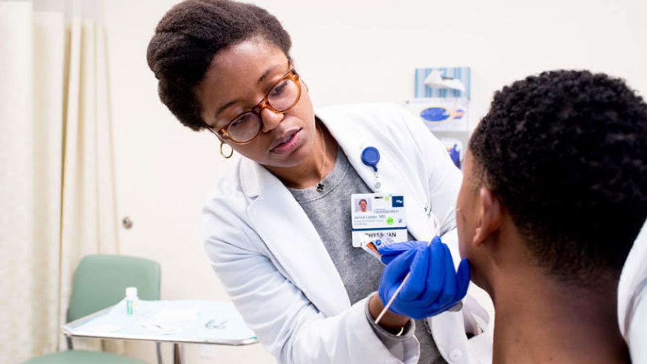 Dr. Jenna Lester, M.D., dermatologist and assistant professor of dermatology, treats her patient Geoffry Blair Hutto in the UCSF Primary Care clinic at China Basin.