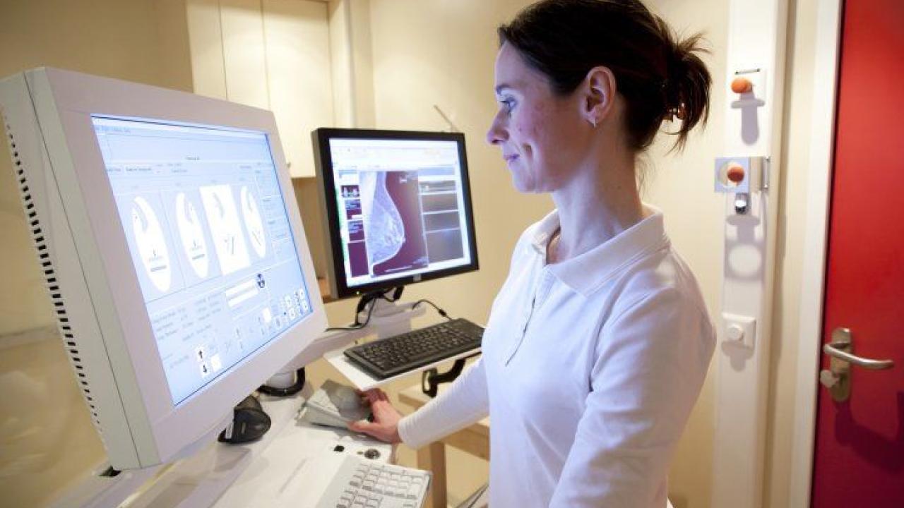 Physician reviews mammography images.