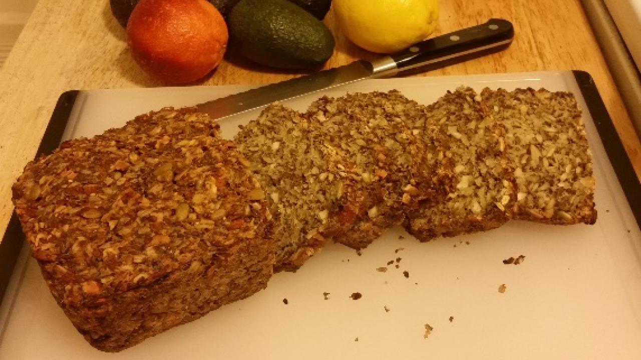 sliced nut and seed bread on a cutting board