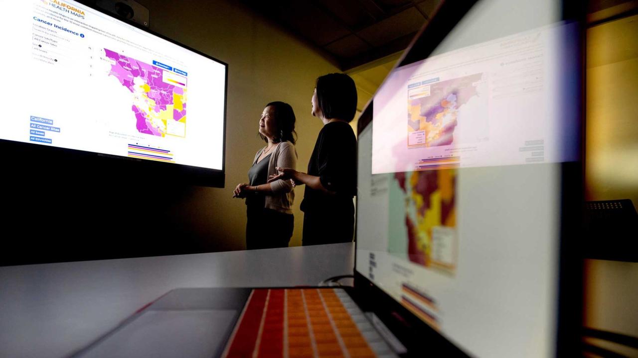 Scarlett Gomez, PhD, MPH (left), examines Bay Area cancer rates. Photo by Noah Berger