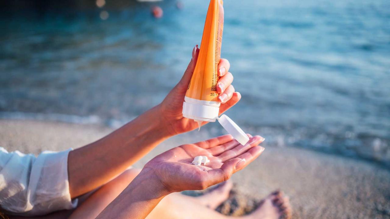 Sunscreen being squeezed into a palm