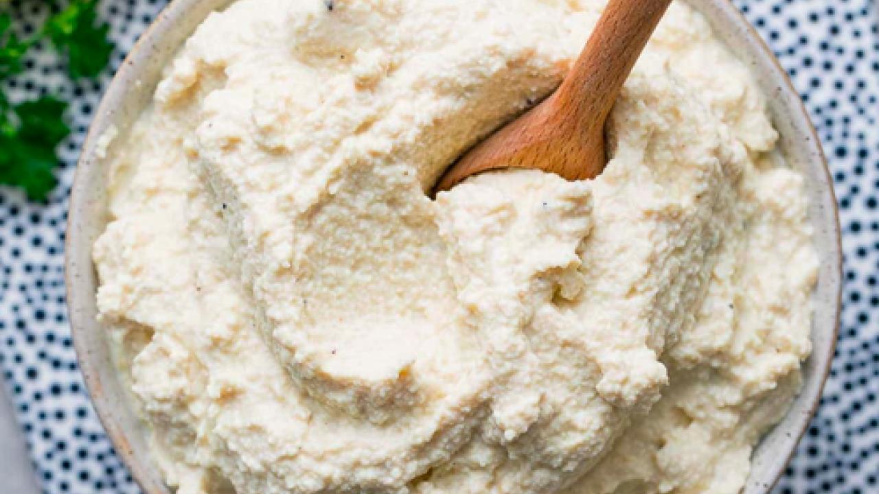 bowl of tofu ricotta with wooden spoon