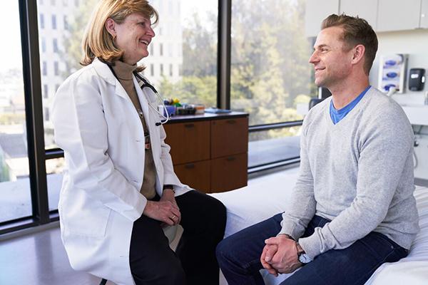 Dr. Karin Gaenser speaking with a patient in clinic