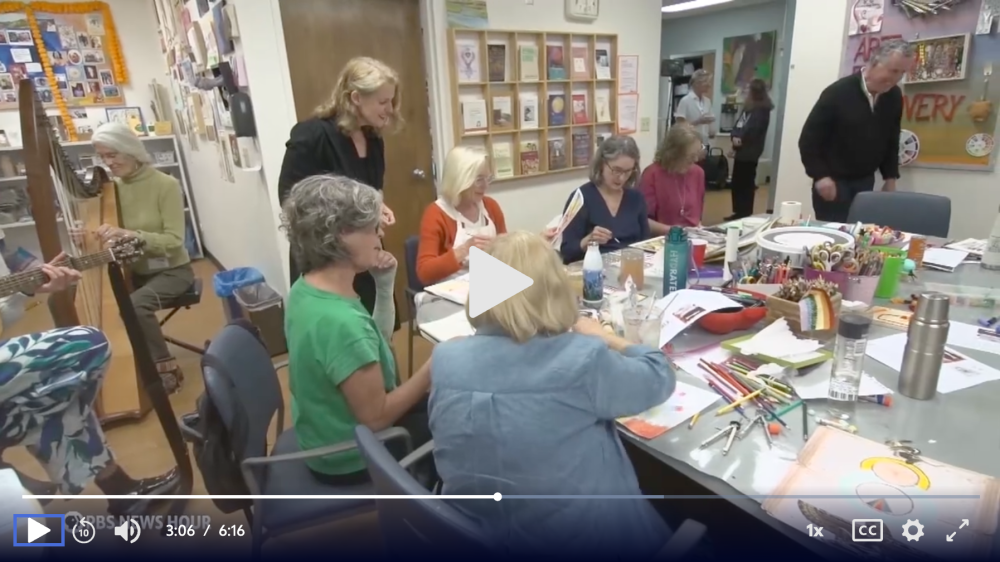 UCSF Art for Recovery participants work on art projects together while sitting around a table.