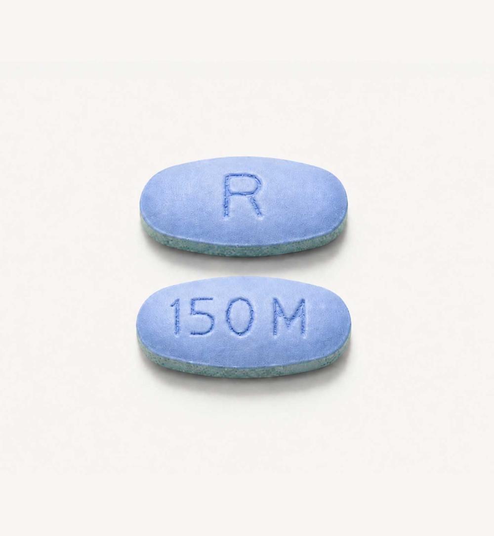Two daraxonrasib pills, which are blue and oval in shape.