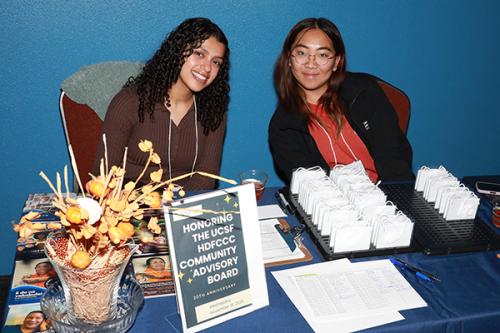 Office of Community Engagement staff welcome attendees at reception table