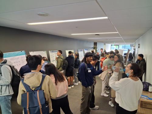 Cancer research trainees at a scientific poster session