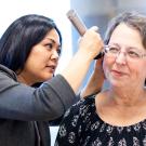 Doctor examines a patientʻs ear for signs of tinnitus