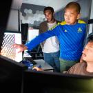 UCSF professor Yifan Cheng, PhD (center), gestures while examining a Cryo-EM sample along with associate researcher Rob Seed, PhD (left), postdoctoral scholar Mingliang Jin, PhD (bottom right), and professor Stephen Nishimura, PhD (right). Photo by Noah Berger
