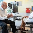 Aparajita Singh, MD, meets with patient Bill Shea, who was previously diagnosed with colon cancer. Photo by Deanne Fitzmaurice