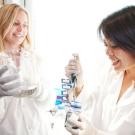 Two women in lab coats exchanging information