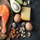 Foods for ketogenic diets, which include high-fat foods like salmon, avocado, eggs, nuts, broccoli, asparagus, and cheese.