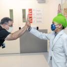 A young male patient named Manwar high fives a nurse at Benioff Children's Hospital Oakland.
