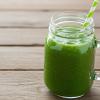 green smoothie in jar with straw
